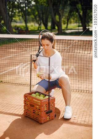 Tennis player going through tennis curt. Model posing. Hobbies, sports, equipment. 101017010