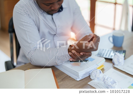 Burnout American African business man in stress works with many paperwork document, migraine attack, Freelance, work from home. Burnout American African business man in stress works with many paperwork document, migraine attack, Freelance, work from home. 101017228