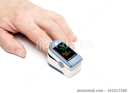 Pulse oximeter device used on finger on white 101017580