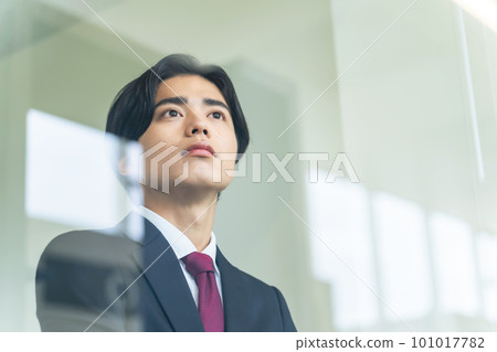 Young businessman looking out the window Young businessman looking out the window 101017782