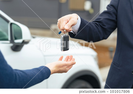 Man handing car smart key Car rental delivery 101017806