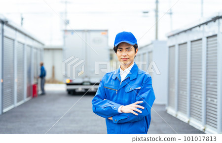 A worker standing in front of a container warehouse 101017813