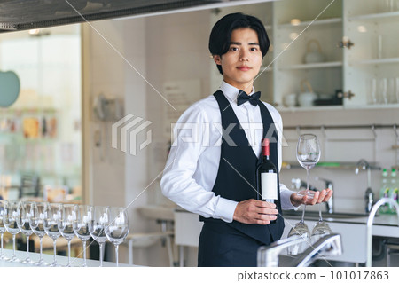man carrying wine bottle and wine glass 101017863