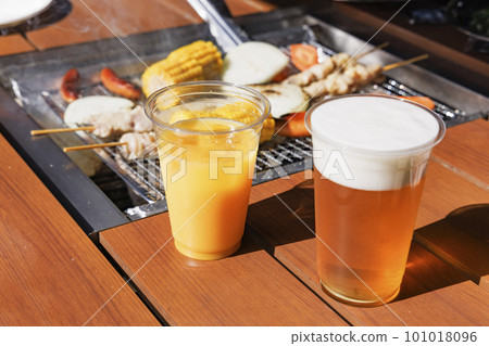 Chilled draft beer and orange juice to drink at the barbecue Chilled draft beer and orange juice to drink at the barbecue 101018096