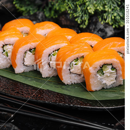 Salmon sushi with rice on black plate Salmon sushi with rice on black plate 101018241