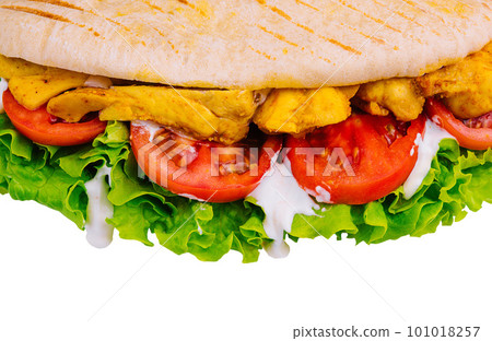 Doner kebab - fried chicken meat with vegetables in pita bread 101018257