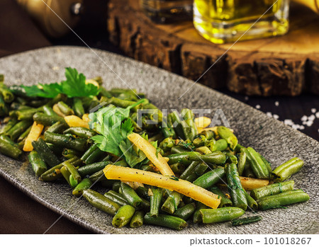 Fried wok green beans with onions and spices 101018267