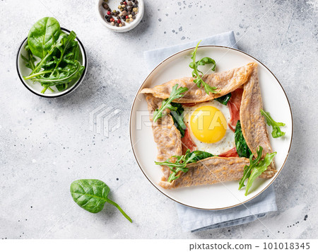 buckwheat crepe with egg, prosciutto and spinach buckwheat crepe with egg, prosciutto and spinach 101018345