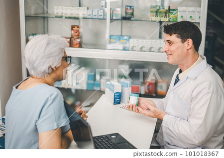 Pharmacist giving advice And advice for patients who come to buy Medicine, Drugs, Vitamins products, according to prescriptions in modern pharmacies. 101018367