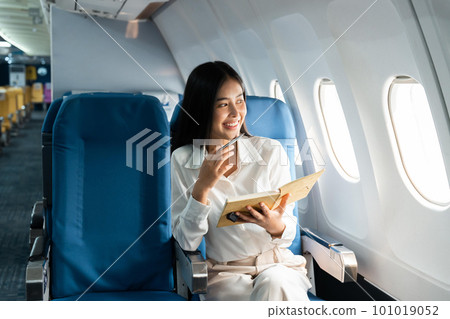 Asian female thinking about work in airplane concept Business traveling and technology concept Asian female thinking about work in airplane concept Business traveling and technology concept 101019052