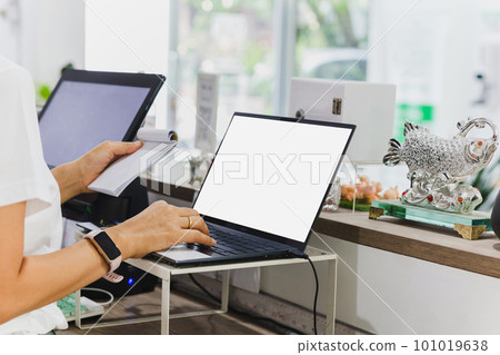 Woman restaurant owner working on laptop at cashier counter. Woman restaurant owner working on laptop at cashier counter. 101019638
