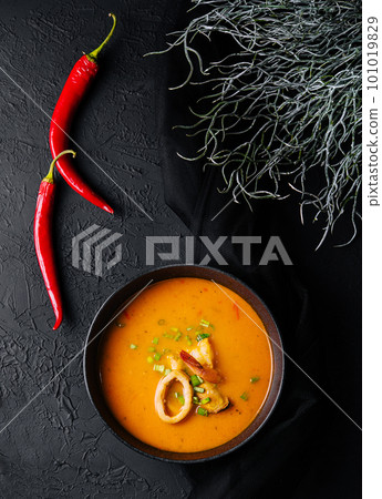 Tom yam seafood soup from above on black stone 101019829