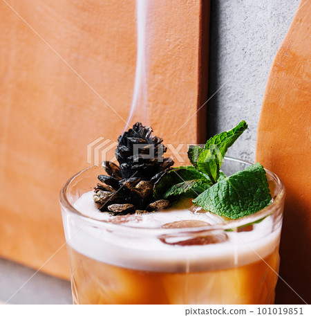Cocktail with preserved sweet cedar cone 101019851