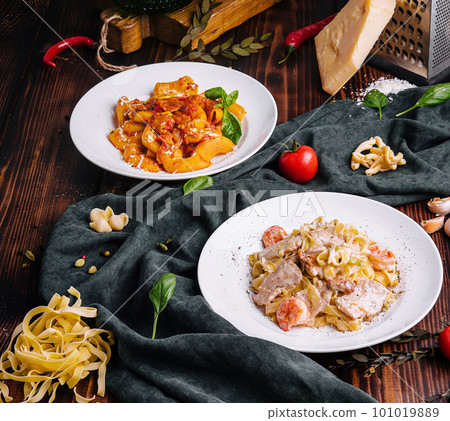 different pasta dishes on wooden with fabric background 101019889