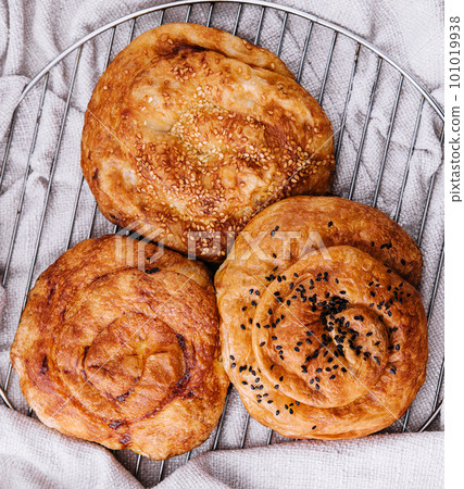 Three raisins buns on a cloth background 101019938
