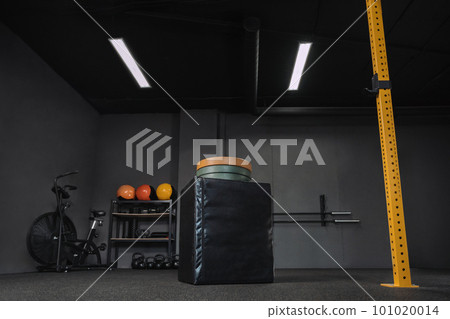 Empty dark crossfit gym. Professional sports equipment for workout Empty dark crossfit gym. Professional sports equipment for workout 101020014