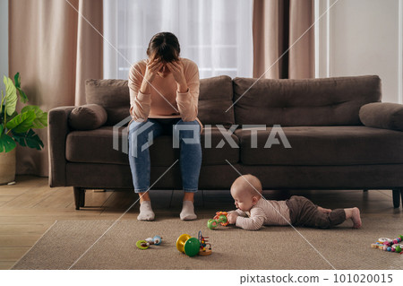Desperate mother tired from motherhood and suffering from depression Desperate mother tired from motherhood and suffering from depression 101020015
