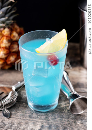 Deep blue sea martini cocktail on wooden table 101020388