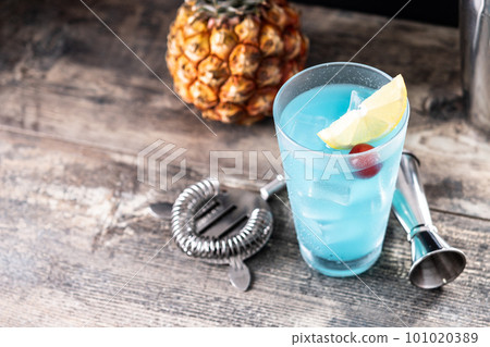 Deep blue sea martini cocktail on wooden table Deep blue sea martini cocktail on wooden table 101020389