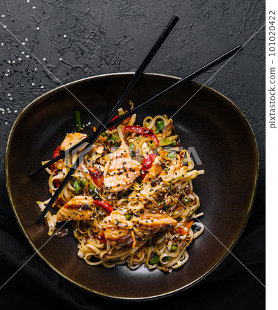 Fried noodles with chicken on top view 101020422