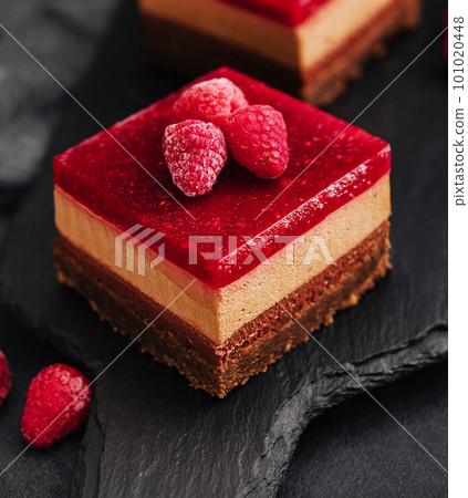 Delicious chocolate mousse cake with raspberries jelly 101020448