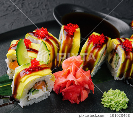 Green dragon sushi roll with eel on black stone 101020468