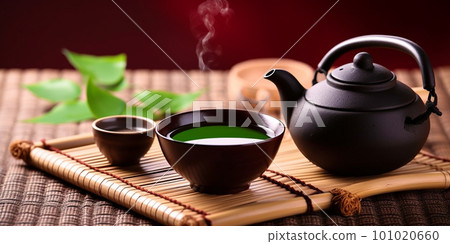 Asian tea set. Japanese teapot and cups on bamboo mat. Hot tea in pot and teacups 101020660