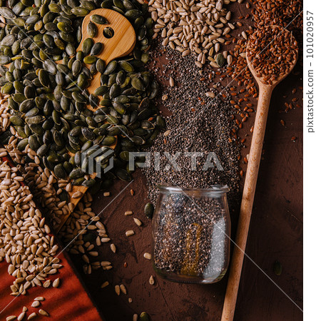 Different types of grains and seeds on shabby wooden 101020957