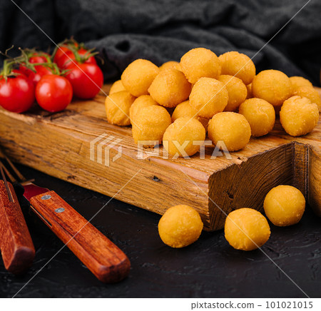 Tasty cheese balls on a wooden Board 101021015