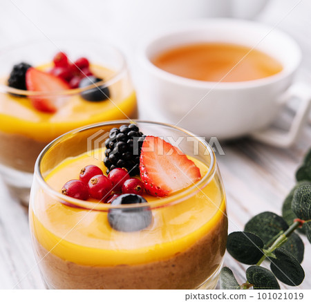 Delicious panna cotta with mango with berries Delicious panna cotta with mango with berries 101021019