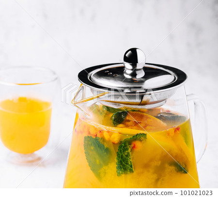 tea with mint and orange. aromatic hot drink in glass jar. 101021023