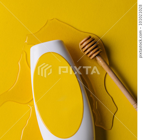 blank shampoo bottle and honey stick 101021028