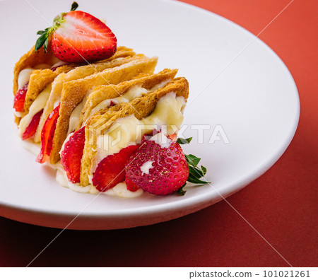 Strawberries and cream mille feuille dessert on plate Strawberries and cream mille feuille dessert on plate 101021261