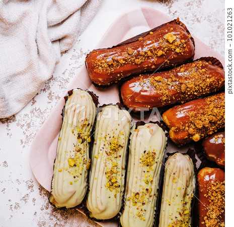 traditional french eclairs with chocolate and vanilla cream and cup of espresso traditional french eclairs with chocolate and vanilla cream and cup of espresso 101021263