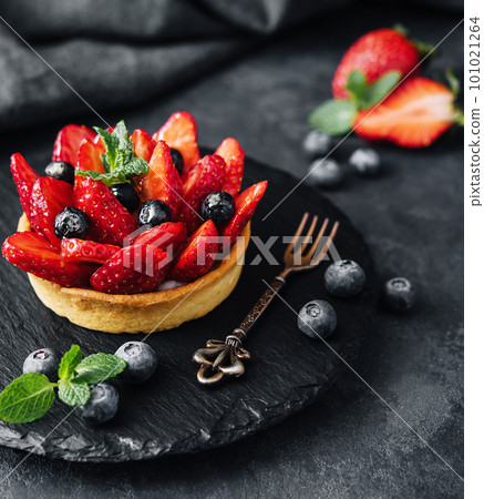 strawberry pieces and blueberry berries into the waffle basket 101021264