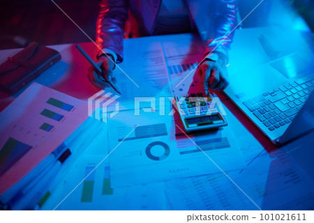 Closeup on modern woman with calculator, documents and laptop Closeup on modern woman with calculator, documents and laptop 101021611