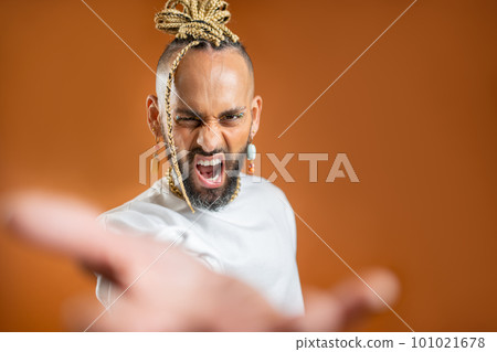 Black latin gay man outstretching empty hand towards camera Black latin gay man outstretching empty hand towards camera 101021678