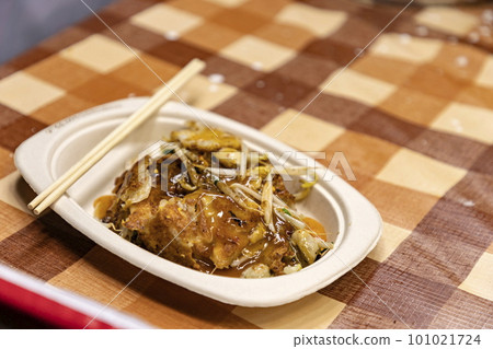 Hoy-Tod Delicious Thai food made from oysters, flour, egg and fried until crispy. Famous Thai food. Put in a disposable paper plate on a table covered with plastic checkered cloth. Selective focus. Hoy-Tod Delicious Thai food made from oysters, flour, egg and fried until crispy. Famous Thai food. Put in a disposable paper plate on a table covered with plastic checkered cloth. Selective focus. 101021724