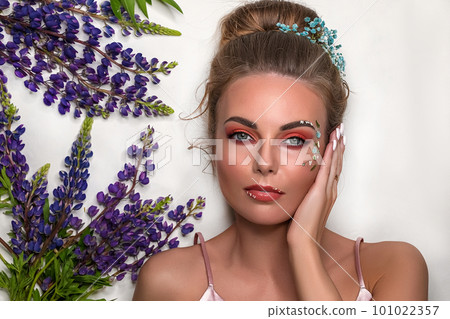 Portrait of a young sassy girl with blond hair in the studio on a pink background. 101022357