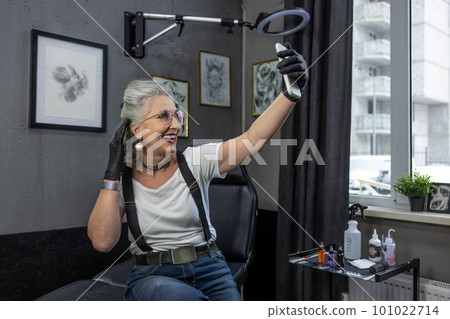 Excited mature woman making selfie and smiling 101022714