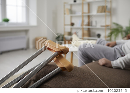Cropped view of man with leg in plaster bandage and crutches Cropped view of man with leg in plaster bandage and crutches 101023243
