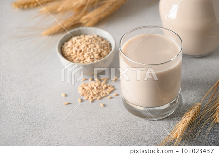 Vegan Barley milk in glass, plant based milk replacer. 101023437