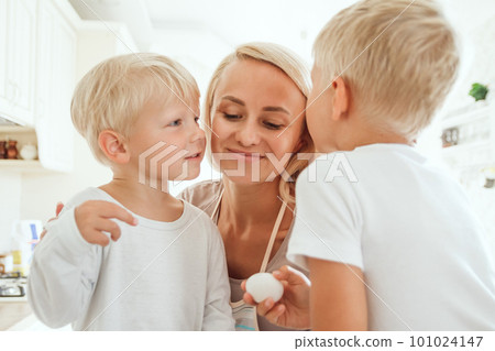Mom with two sons cooking holiday pie in the kitchen. Casual lif 101024147