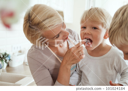 Mom with son cooking holiday pie in the kitchen. 101024184