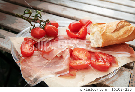 Parma ham, tomatoes and a piece of baguette. Parma ham, tomatoes and a piece of baguette. 101024236