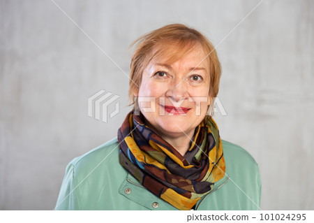 Closeup smiling senior lady in jacket and neck scarf Closeup smiling senior lady in jacket and neck scarf 101024295