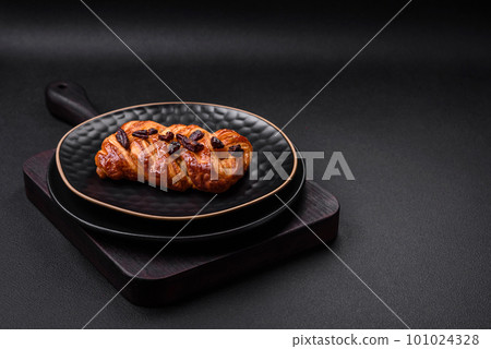 Delicious fresh baked pigtail bun with nuts and syrup 101024328