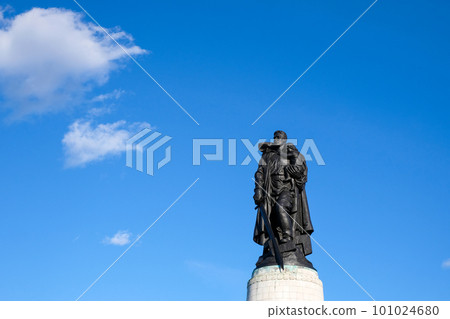 Monument to a Soviet soldier with a sword holding a German child at the Soviet War Memorial in Treptower Park, Berlin, Germany 101024680