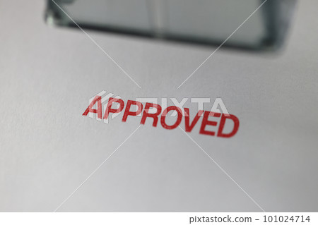 Red word Approved stamped on papers close upper view 101024714