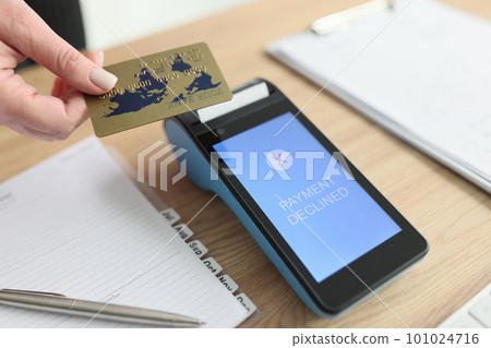 Woman puts card to terminal trying to pay for services 101024716